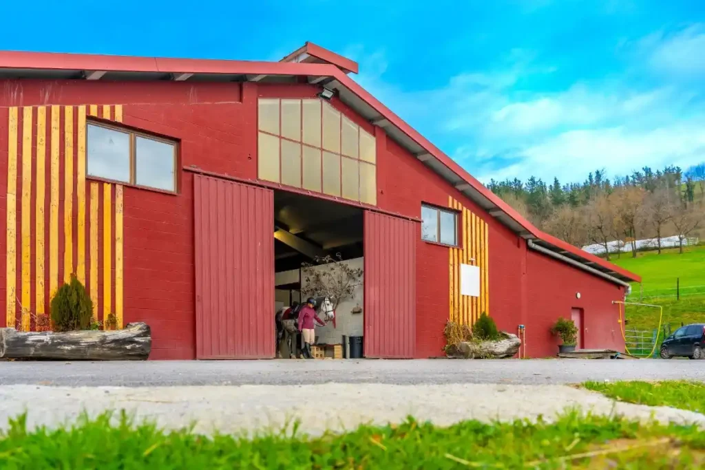 Montana pole barns used as horse riding arenas with large sliding doors and equestrian facilities.
