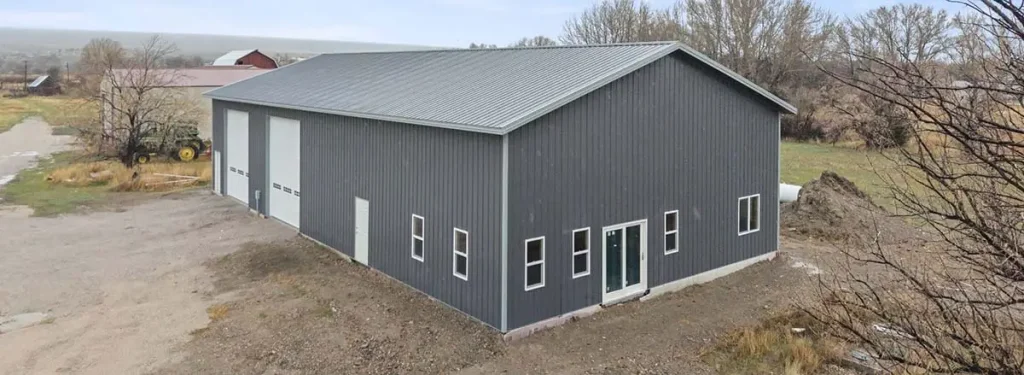 Montana pole barns featuring the Norris Rd Arena custom post-frame building with large overhead doors.