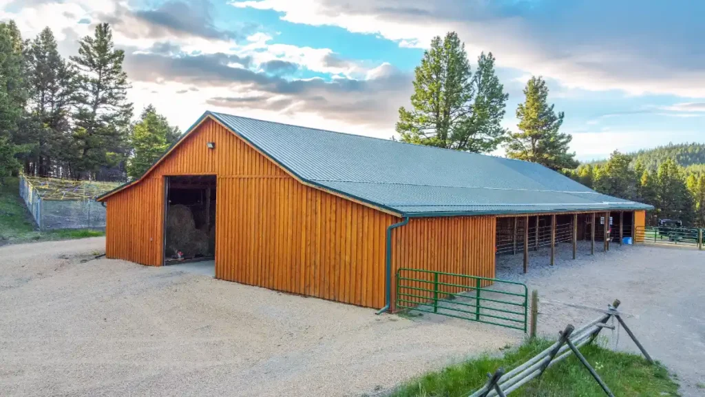 Hobby shop building costs for a large post-frame workshop with covered storage and durable metal roofing.
