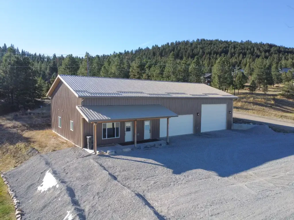 Hobby shop building costs for a custom metal workshop with overhead doors, office space, and gravel access.