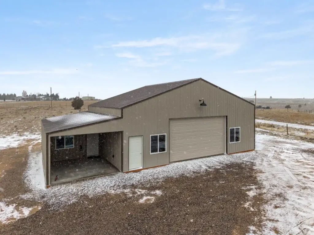 Hobby shop building costs for a rural steel workshop with an attached lean-to and oversized garage door.